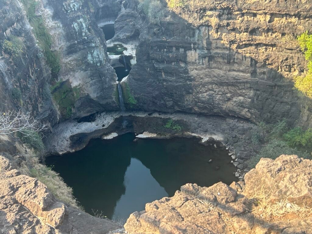 A hidden waterfall flowing through the rocky gorge in the scenic Ajanta valley near the famous Ajanta Caves.