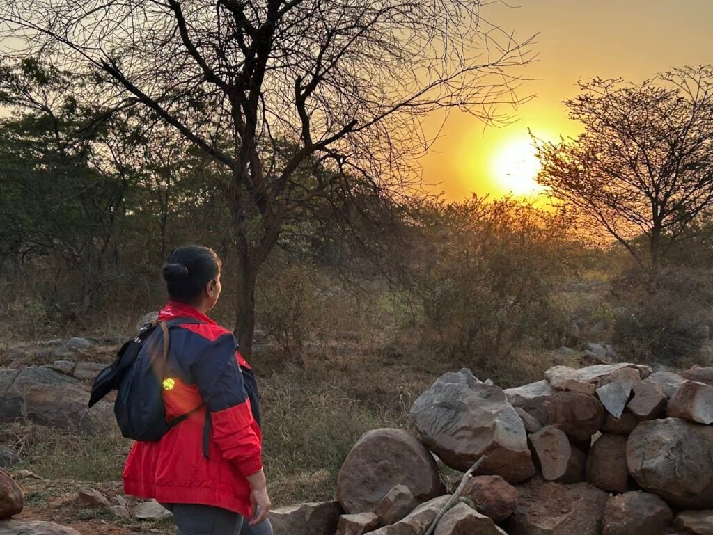 Solo Traveler Watching Sunset in the Wilderness
