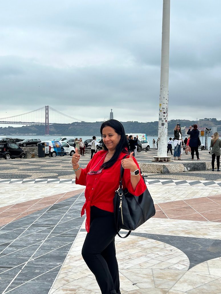 Solo Traveler at the Lisbon Waterfront with 25 de Abril Bridge View
