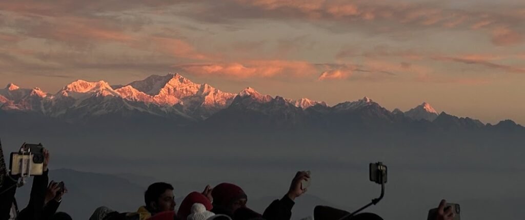 Watching the first light of sunrise illuminate the Kanchenjunga range from Tiger Hill in Darjeeling.