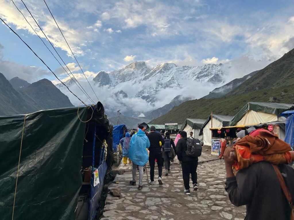 pilgrims trekking toward Kedarnath temple on a mountain trail in the Garhwal Himalaya