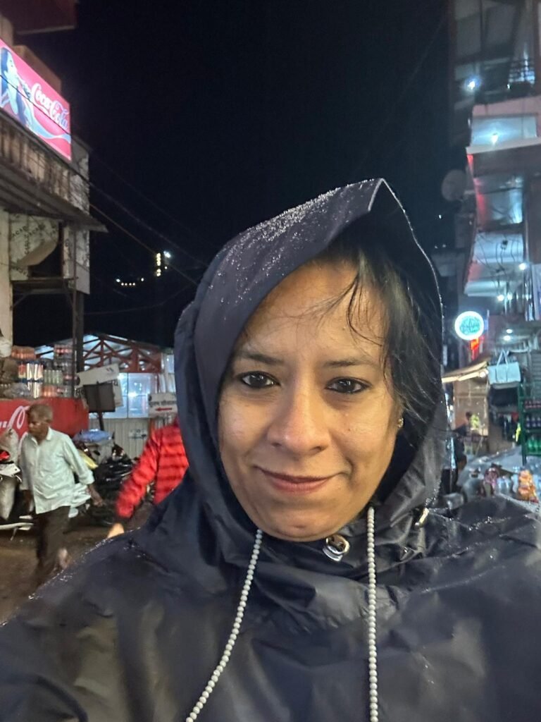 “Solo female traveler walking in rainy night street market in India during travel”