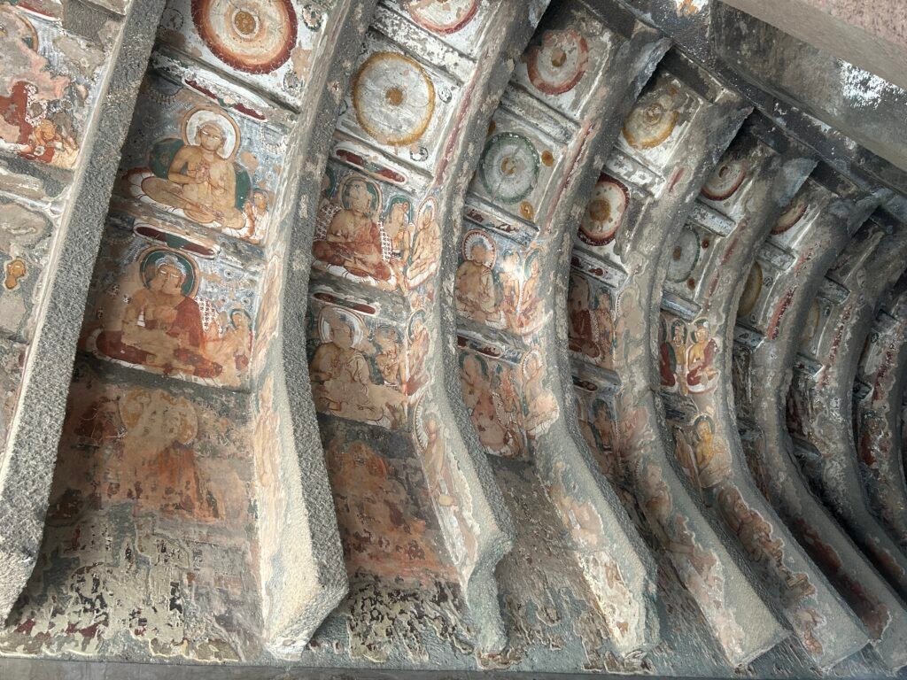 Centuries-old Buddhist murals and painted pillars illuminate the quiet interior of Ajanta’s caves.