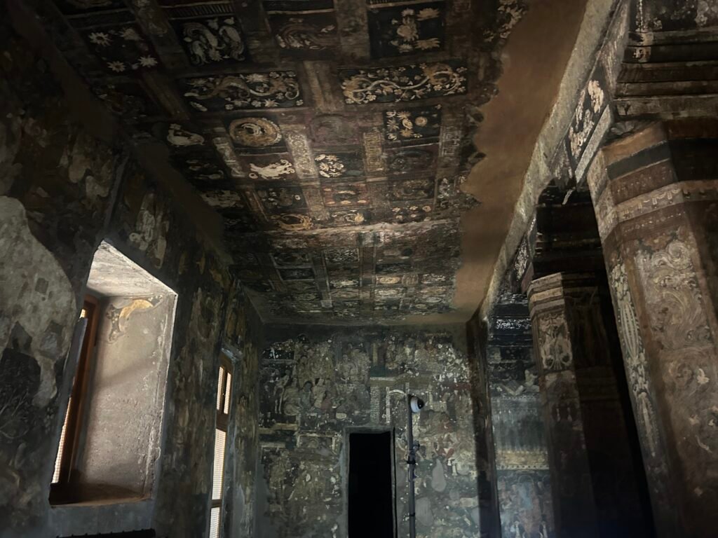 Ancient Ajanta cave murals illuminated by natural light