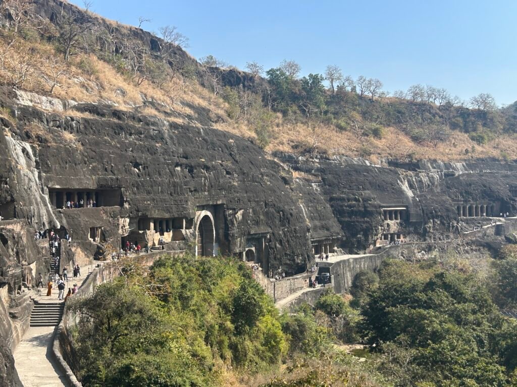 Ajanta caves carved into a horseshoe-shaped cliff above the Waghora River