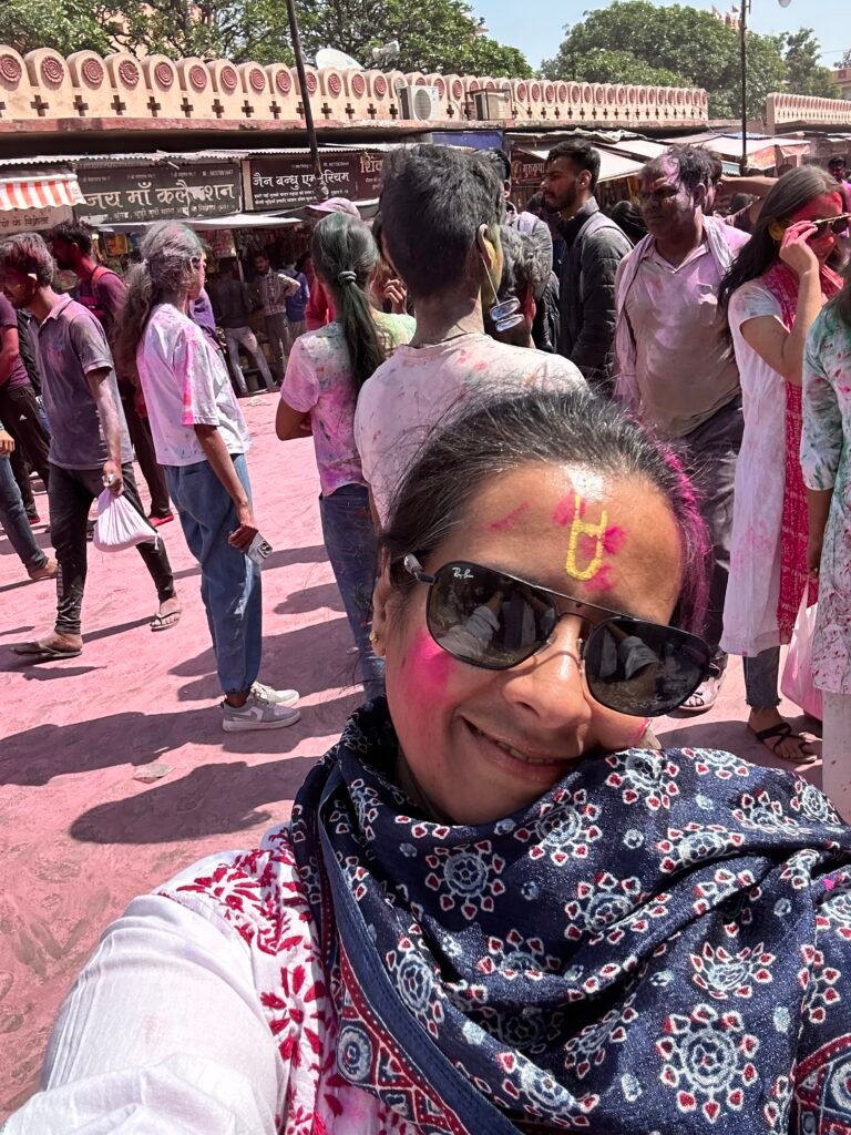 Crowds enjoying the vibrant Holi festival in Agra with colorful powder and celebrations.