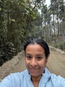 Travel selfie on a rural village road surrounded by areca palm trees in the Dooars region of West Bengal, India.