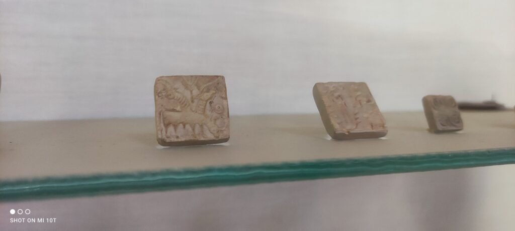 Ancient Indus Valley seals with animal carvings displayed at the Dholavira archaeological site museum in Gujarat.